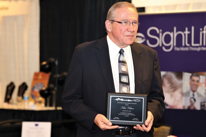 MFDA-Convention-man-holding-plaque