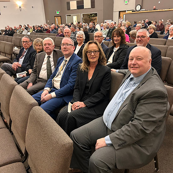 Pictured seated in an auditorium are MFDA Executive Director Terri James; MFDA Past Presidents Tyson Moore, Rick Evans, Steve Schnider (and wife Carla) and Bill Rothie; Lee Darlington; Fred and Sherry Nelson; and Steve and Denise Schnackenberg.