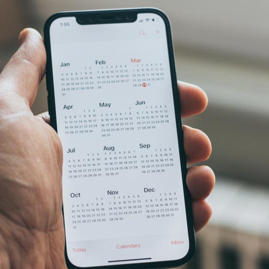 Upcoming Events. Hand holding phone open to calendar.